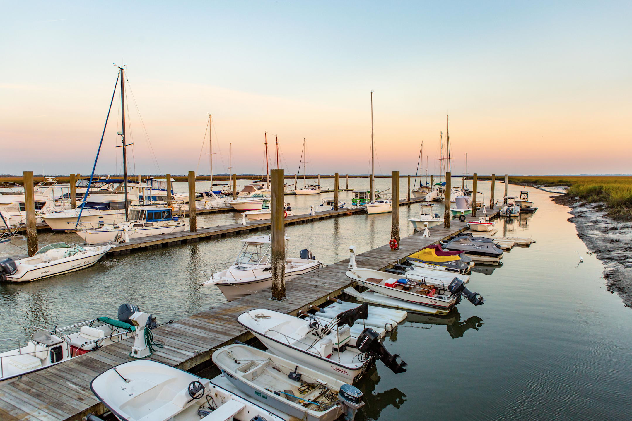 A boat marina with several boats docked on the water.