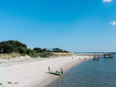 View of beach, ocean and kayakers with blue skies