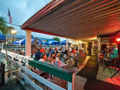 People enjoying outdoor evening dining with live music.
