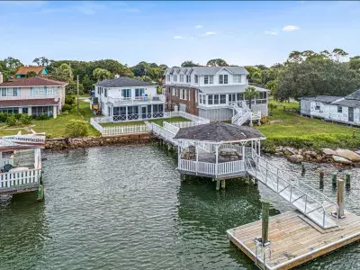 An aerial view of water views and numerous homes on the water.
