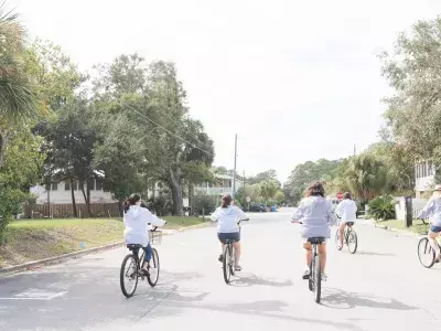 A group of five women riding bikes.