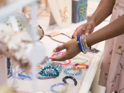 A person shopping for handmade jewelry.